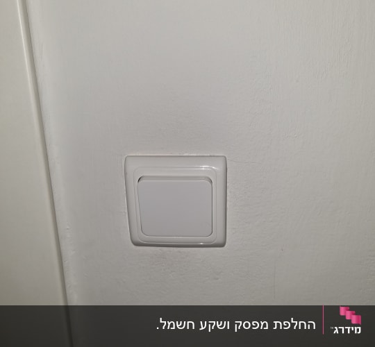 מתג חשמלי לבן על קיר